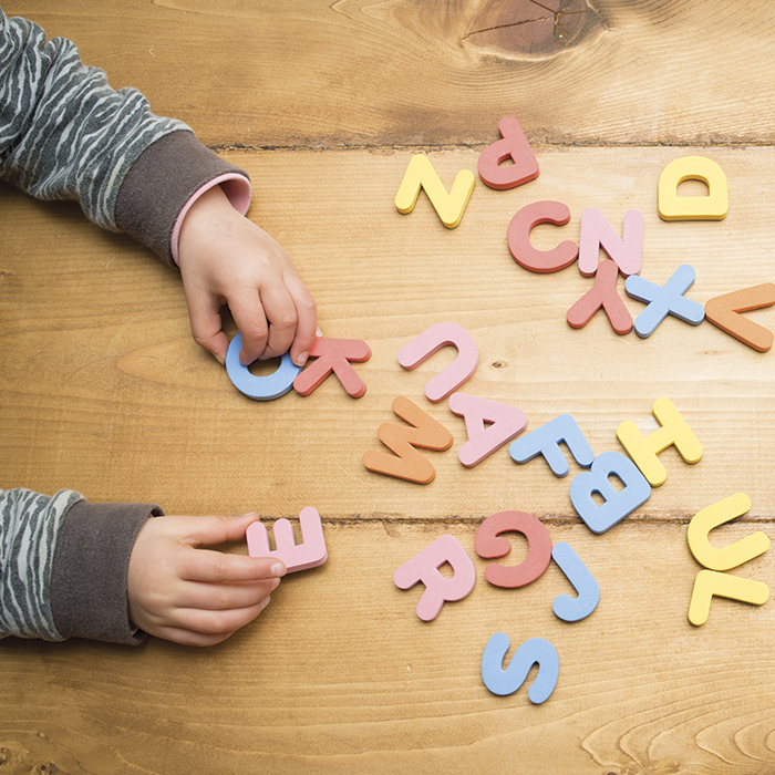Child playing with foam letters on table